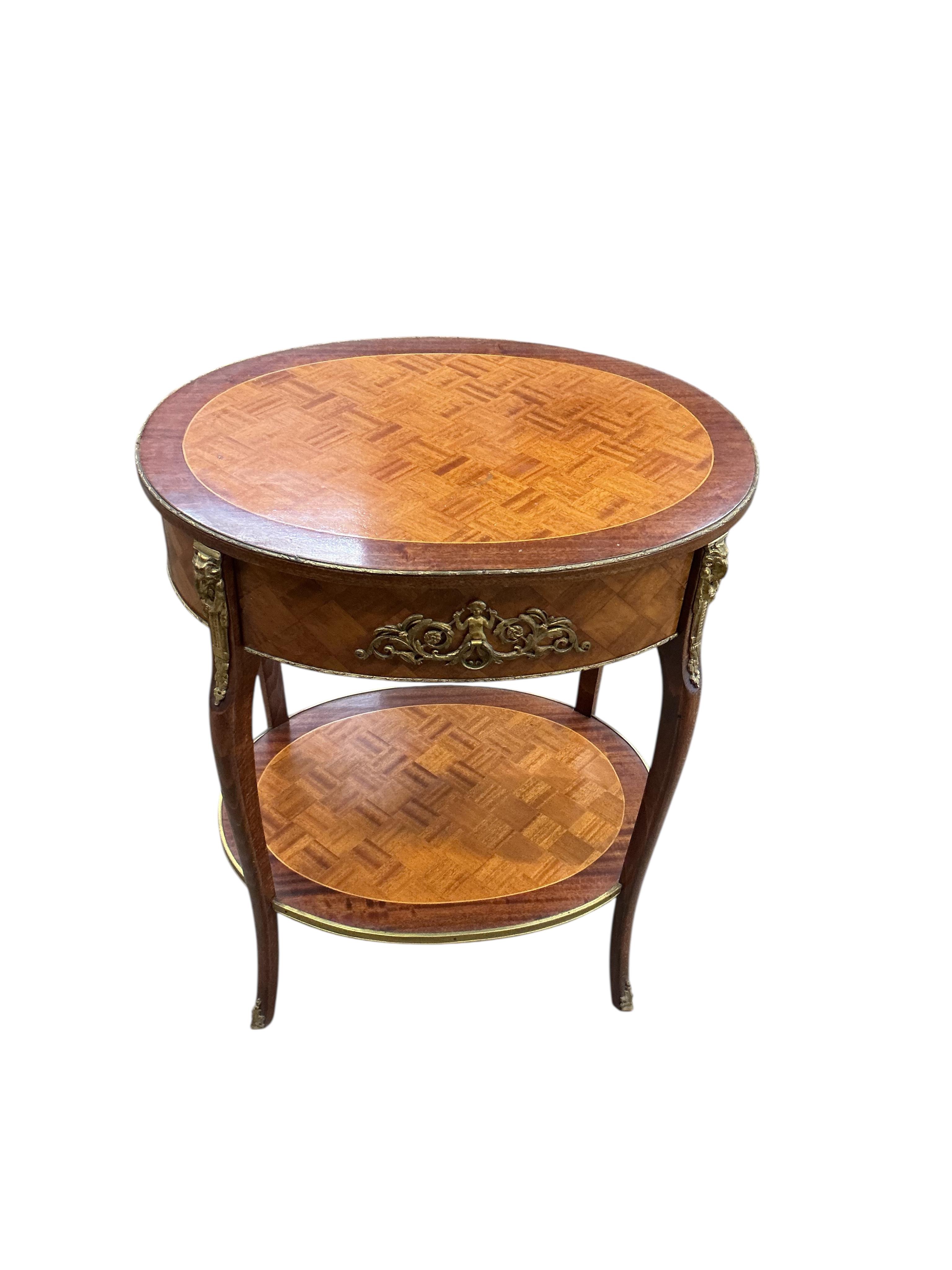 An early 20th century French transitional style gilt metal mounted satinwood parquetry and mahogany oval two tier table, width 53cm, depth 41cm, height 68cm